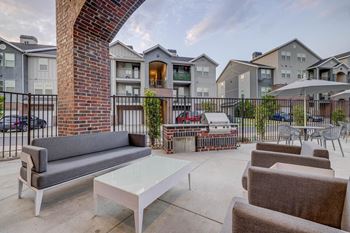 our apartments have a large patio with furniture and a grill